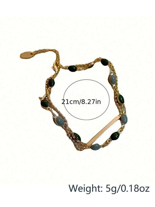 خلخال بلون ذهبي طبقتين – خلخال بسلسلة خرز باللونين الأخضر والرمادي مع تفاصيل شريطية – حلي قدم نسائية أنيقة