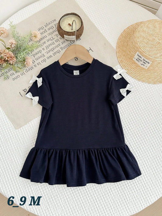 فستان قطني للبنات الصغيرات مزين بالكشكشة وتفاصيل الفيونكة (6-9 أشهر)