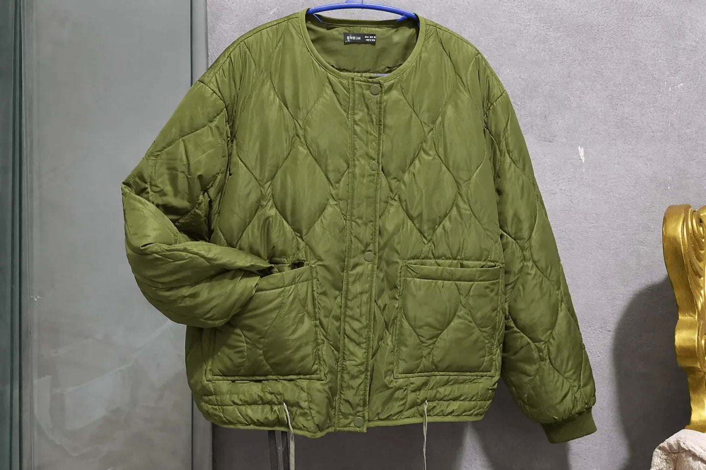 A lightweight winter jacket in a trendy olive green color
